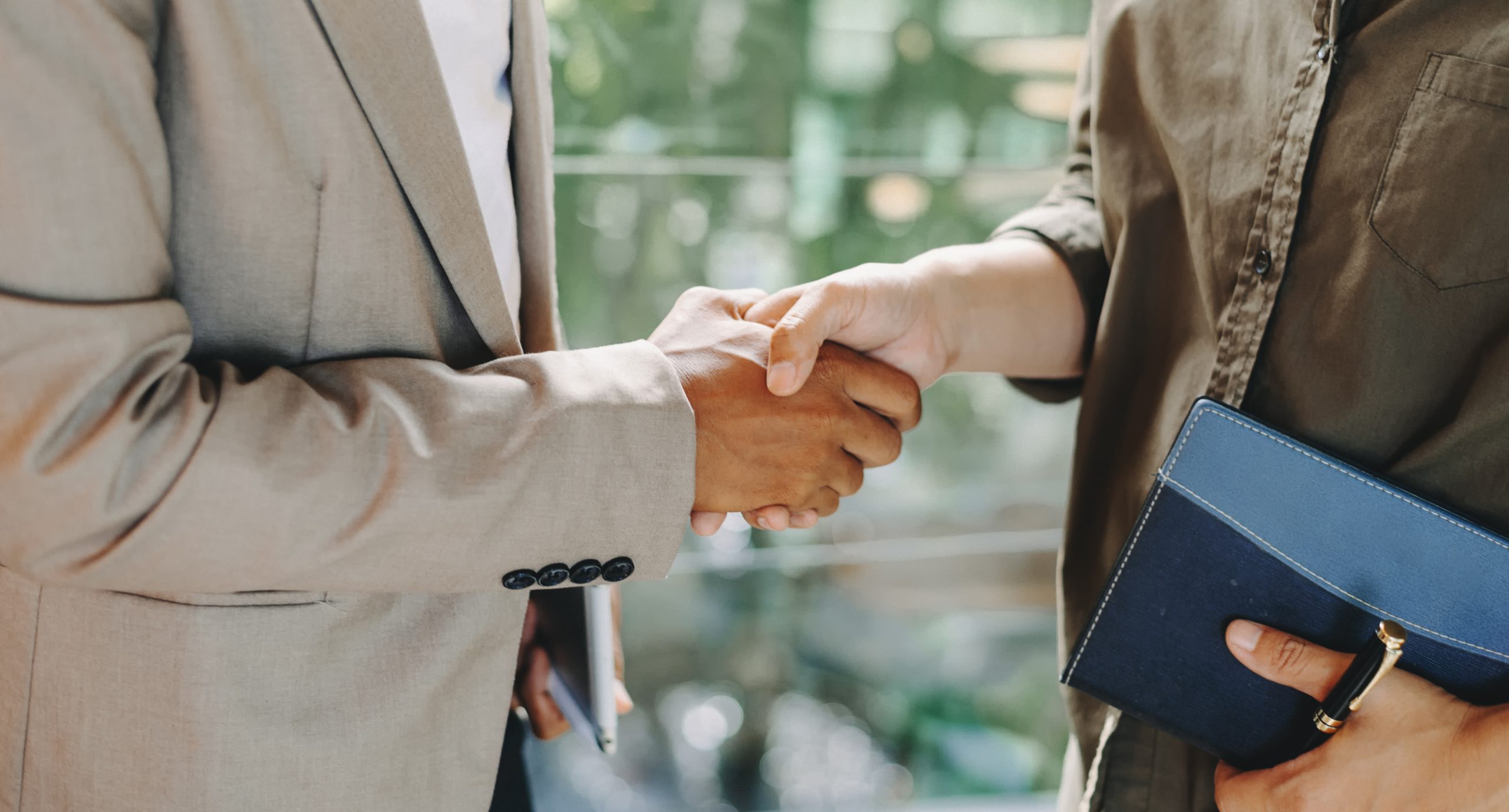 Two confident business man shaking hands during a meeting in the